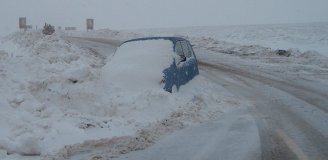 Car abandoned in snow drift